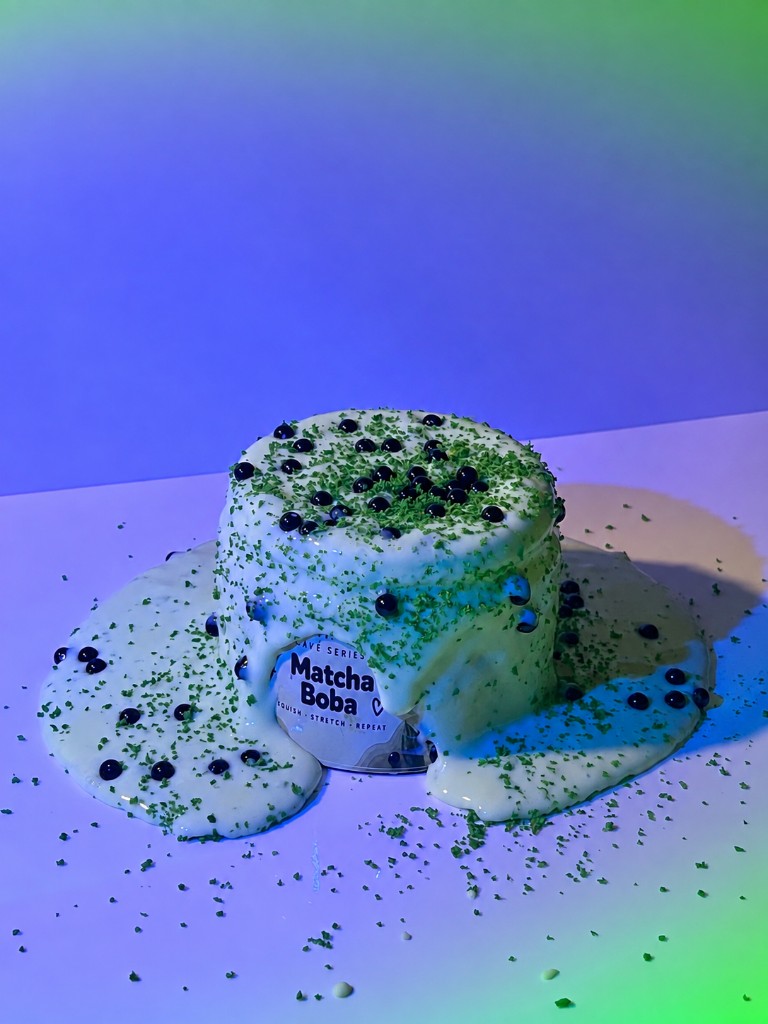 Matcha Boba slime jar overflowing with cream, matcha dust and boba pearls